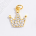 Macro shot of gold-plated crown pendant with micro-paved white cubic zirconia stones - Gold Crown Pendant
