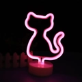 Neon cat desk lamp with soft pink glow on a circular base for modern home decoration - Pink Cat