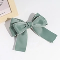 Detailed view of Morandi green bow hair clip with white stitching and satin texture - Green