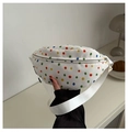 Close-up of a white canvas chest bag featuring colorful polka dots and an adjustable strap - White