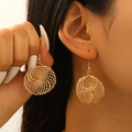 Detail of gold spiral wire hoop earrings with elegant layered metallic design on model - Gold (KC Gold 5725)