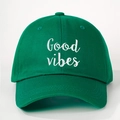 Close-up of green cotton baseball cap with white Good Vibes embroidery and stitching - Olive Green