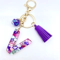 Letter V resin keychain with colorful stones, purple tassel and golden metal clip - Letter V
