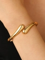 Polished gold open cuff bracelet with teardrop ends on a female wrist - Small Water Drop Open Bangle (9449) / KC Gold