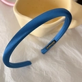Close-up of a blue satin sponge headband showing the handmade label and fabric texture - Royal Blue