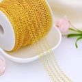 Detail of 18K gold-plated copper chain on a white spool for DIY jewelry making - 3mm Extension Chain / Thick Silver