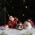 Set of four resin Christmas figurines featuring Santa Claus and three decorative snowmen - Santa & Snowman Mixed (Set of 4)
