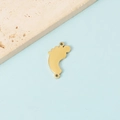 Detailed view of gold baby feet charm with MOM letter and dual rings on a blue background - 18K Gold Plated Double Hole Foot