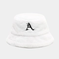 Macro view of plush white faux fur bucket hat with black letter A embroidery texture - White