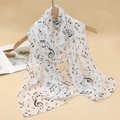 Detail of white chiffon scarf with black music note print hanging on a wooden hanger - White Black Music Note