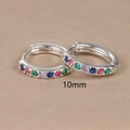 Detail view of 10mm silver huggie earrings with rainbow multi-color inlaid stones - 10mm / Silver