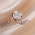 Elegant rotating four-leaf clover ring with white cat eye stone on silk fabric - Rotating Opal Ring (J0067)
