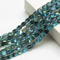 Close-up of flat oval iridescent teal crystal beads for DIY jewelry and lighting decor - Transparent Green