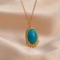 Close-up of turquoise stone pendant in 14K gold plated bezel on pink satin - Oval Turquoise Sunburst (YCN1621)