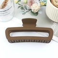 Matte brown square leopard print hair claw clip shown on a white tabletop background - Rubber Coffee