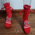 Red Christmas socks with small hand magnets and Happy New Year text on transparent legs - Red Happy New Year Hand Holding