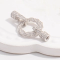 Macro shot of silver rope twist necklace clasp with cubic zirconia pave on ceramic tray - Style C: White Gold Twisted Clasp