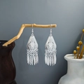 Bohemian silver hollow leaf tassel earrings displayed on a rustic wooden branch - Silver Bohemian Hollow Multi-Metal Tassel Style (E5775-5)