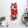 Detail of festive Christmas swag with red berries, pine cones and a large red bow - Red Teardrop Swag with Lights and Pine Cones