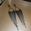 Detailed view of long black rhinestone tassel earrings on a champagne metal tray - Water Drop Tassel Style (3# Gun Black Silver Needle)