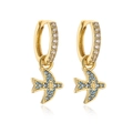 Detailed close-up of 18K gold earrings featuring zircon inlay and a colorful bird charm - Blue Zirconia Dove