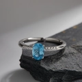 S925 sterling silver ring with oval blue gemstone and side diamonds on a stone base - Topaz Oval Side Diamond Style (LR307)