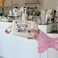 Detail of cute beige corduroy pouch with rabbit embroidery and pink woven handle - Happy Rabbit