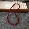 Close-up of red glass bead necklace with silver round clasp on wooden display tray - 4# Necklace - Red (6mm)