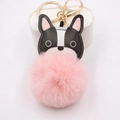 Bulldog bag charm with a large pink pompom and golden keyring on a white display - Pink