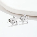 Detailed view of silver minimalist hollow star-shaped stud earrings in polished metal - Star Steel