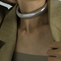 Chunky silver tone coiled spring choker necklace on a model for a bold trendy look - XL27 Steel Color 2cm Width (34+5cm)