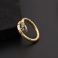 Close-up of golden snake ring featuring blue zircon eyes and detailed scale texture - Snake Scale Texture Blue Gem Style