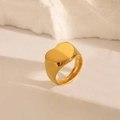 Macro shot of a golden heart-shaped signet ring with a polished minimalist stainless finish - US 6