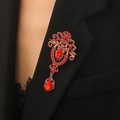 Vintage gold brooch with red crystals and water drop pendant on a black blazer lapel - Gold Red Rhinestone Style (7494)