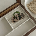 Detailed view of leopard print acetate hair claw clip with a green handle on velvet - Bag Claw Clip