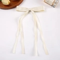 Elegant cream white ribbon bow hair clip with satin finish on clean white background - Off White