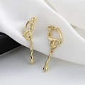 Elegant 18K gold-plated fluid lava long drop earrings displayed on white silk fabric - Hollow Butterfly Earrings / Gold