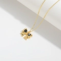 Golden bow pendant necklace featuring black heart-shaped stones and cross chain style - Black Zircon Bow