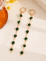 Elegant gold-tone drop earrings with faceted green gemstones on a textured beige surface - Green Round Earrings (5618)