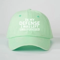 Detail of mint green cotton baseball cap with white printed slogan in macro view - Light Green