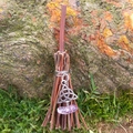 Close-up of mini witch broom pendant with silver Celtic knot and purple quartz stone - 10cm / Branch Broom + Celtic Knot + Random Stone
