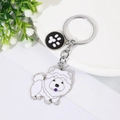 Cute white cartoon dog metal keychain with black paw print charm on a silver link - White Chow Chow