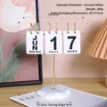 Calendrier à rabat manuel avec cadre en métal doré et base en marbre sur un bureau - Ornement de Calendrier en Fer et Bois - Blanc Croissant