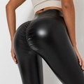 Close-up of high waist black glossy PU leather leggings featuring scrunch butt design - Black