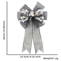 Macro shot of Halloween LED mesh bow showing 38x23.5cm dimensions and silver skull patterns - Style C (Warm Light)