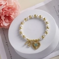 18k gold plated pearl bracelet featuring FE letter and blue heart stone pendant charms - FE Letter and Blue Stone (B)