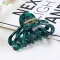 Detailed view of hollow acetate hair claw clip with dark green marble texture and gold spring - Hollow Claw / Dark Green