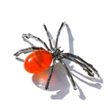 Detailed view of a spider figurine with metallic legs and an oval orange gemstone body - Oval Red Agate