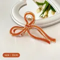 Elegant 11cm bow hair claw clip in translucent amber orange jelly resin finish - Dirty Orange