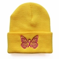 Bright yellow knit beanie featuring pink butterfly embroidery and a warm ribbed texture - Yellow